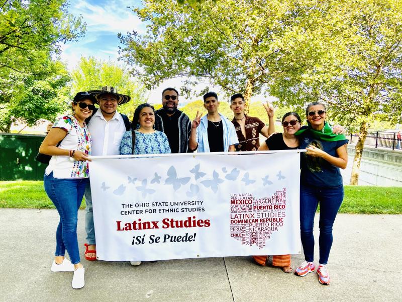 Members of the Latinx Studies community holding a banner.