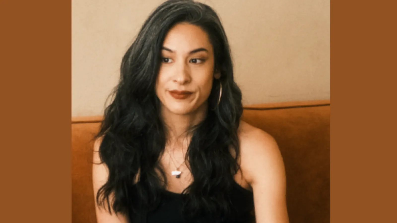 Author Stepahnie Ginese sitting with long dark hair and smiling