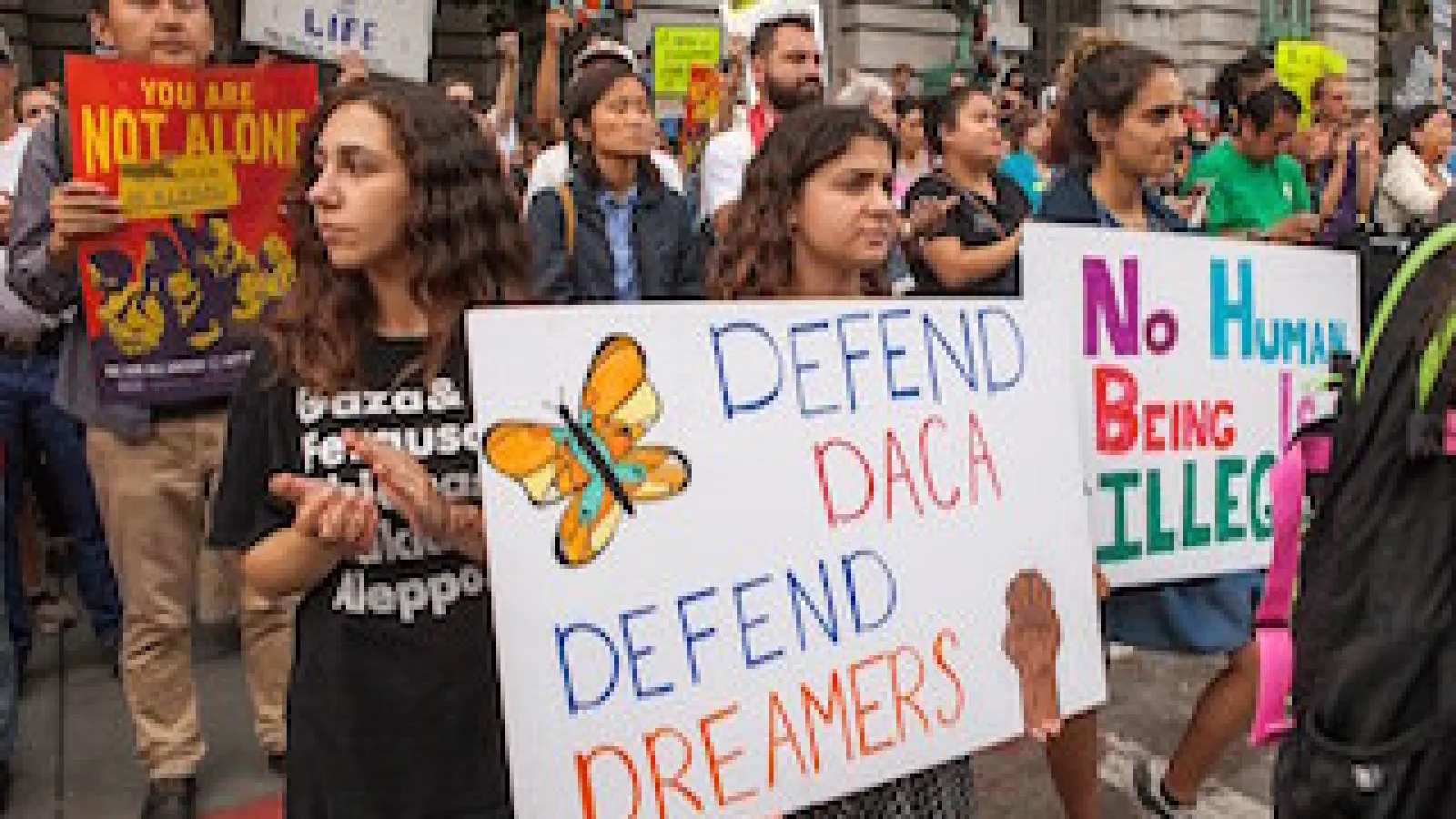 Protesters in San Francisco, September 5, 2017 with posters that read defend daca