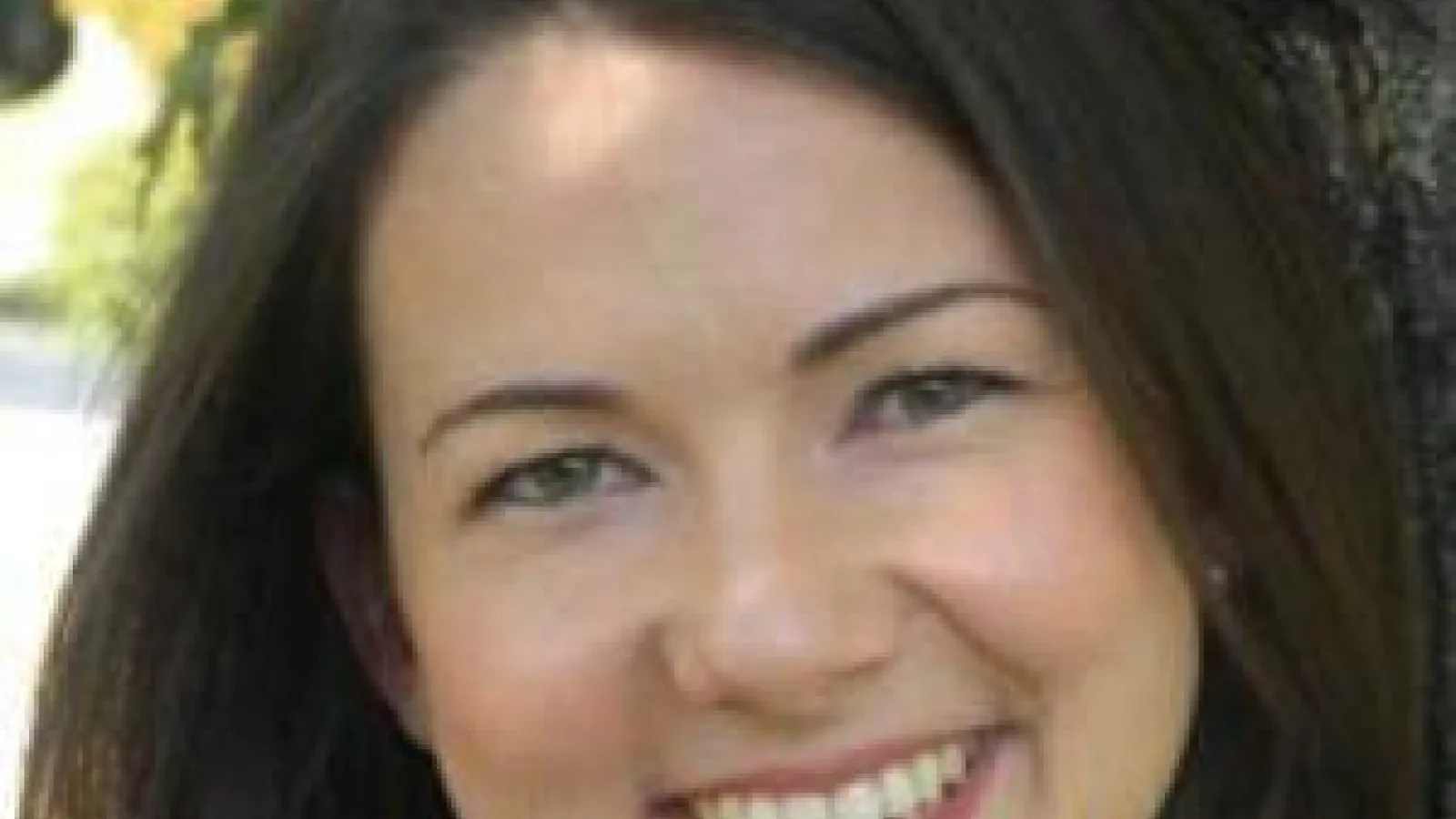 Smiling woman with dark brown hair