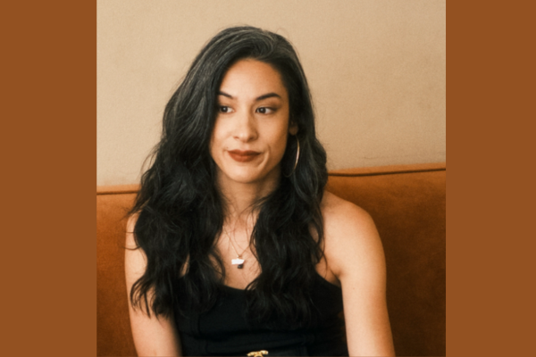 Author Stepahnie Ginese sitting with long dark hair and smiling
