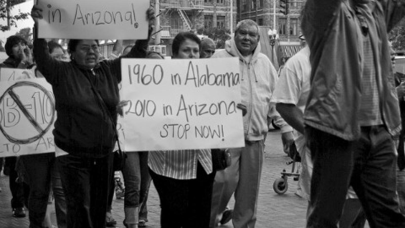 Rally Against SB1070 protesters with signs